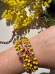 Scopri la bracciale -collana Mimosa: gioiello artigianale in cristalli arancioni e gialli, versatile da indossare come bracciale e collana, per la Festa delle Donne