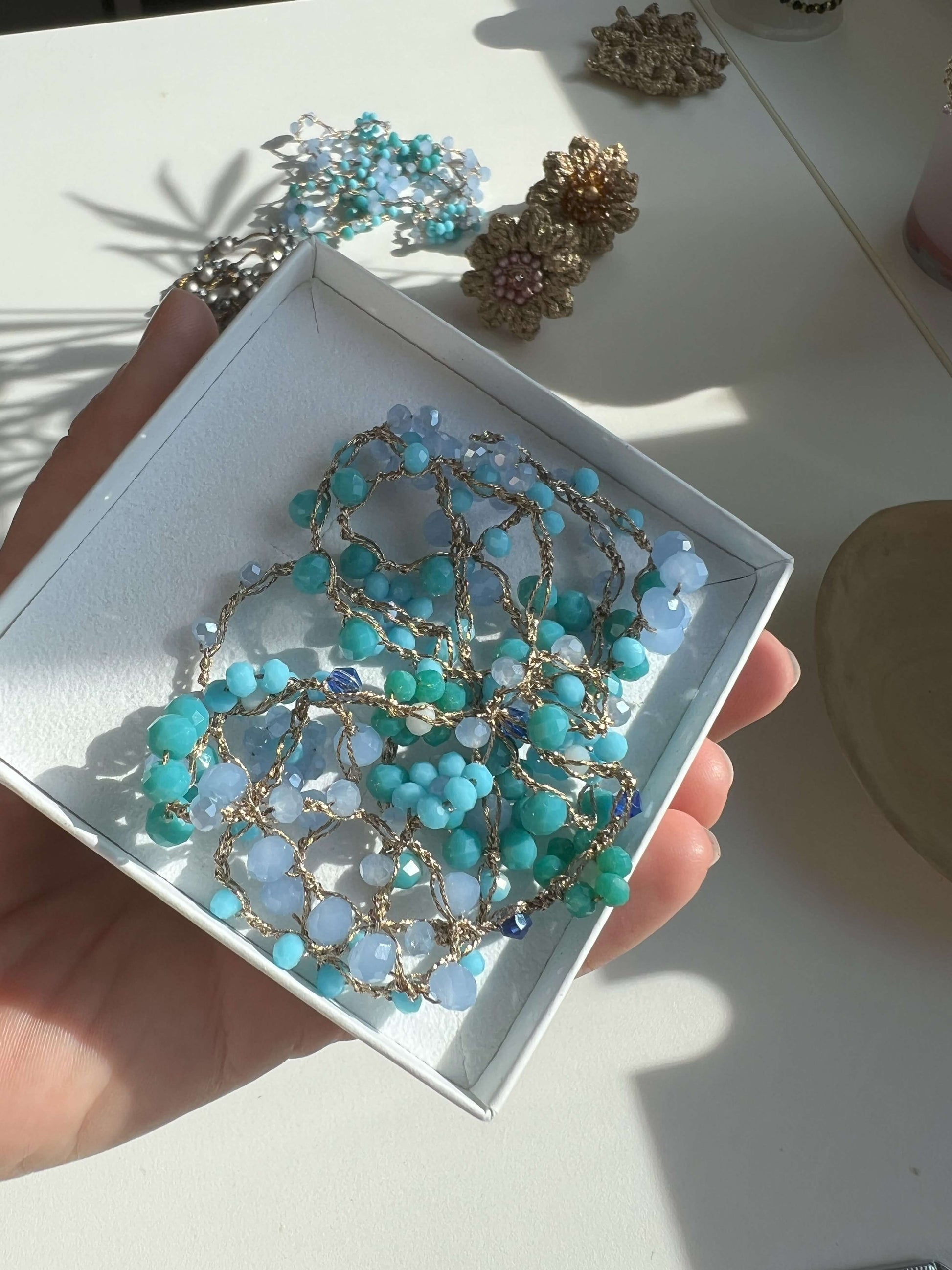 Scopri Giardino Azzurro: collana artigianale floreale, anallergica e senza chiusura. Delicata bellezza ispirata al cielo e alla natura