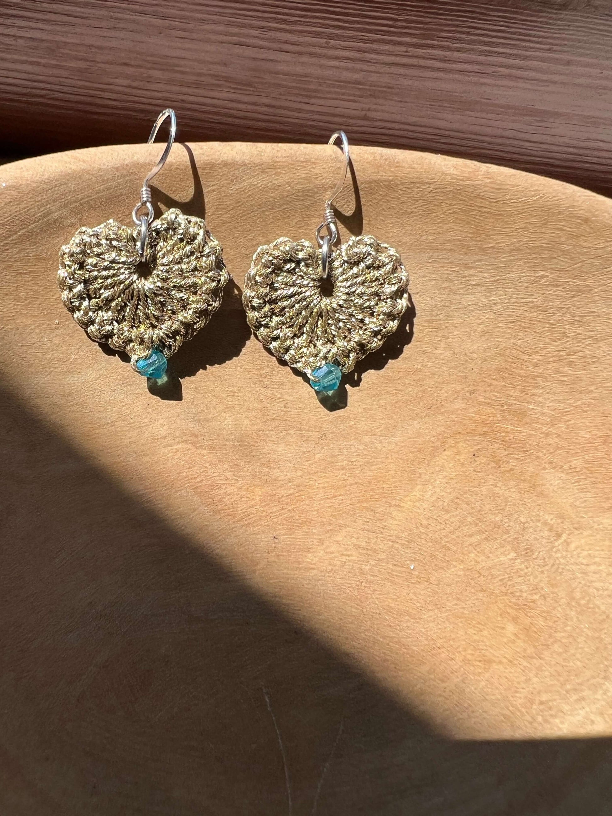 Lightweight handmade heart earrings with a blue crystal and delicate gold-tone jewelry yarn