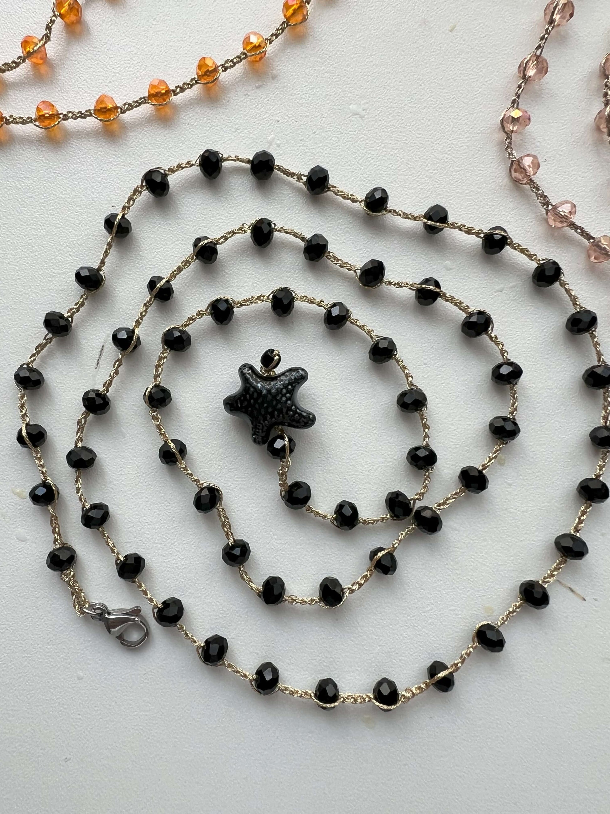 Collana boho nera con stella in ceramica e cristalli, multiuso anche come bracciale wrap. Eleganza versatile per ogni occasione