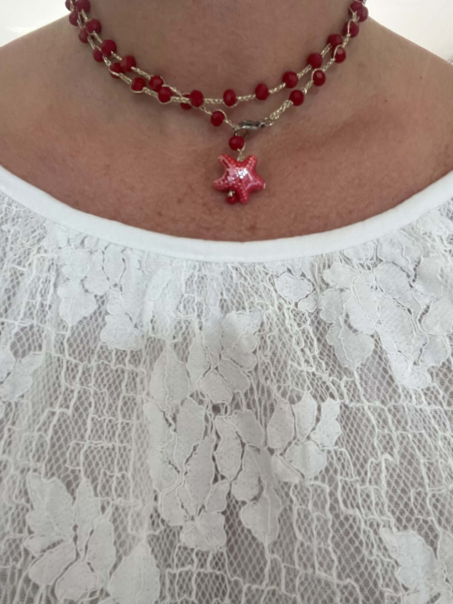 Woman wearing convertible wrap necklace long boho style ceramic star charm