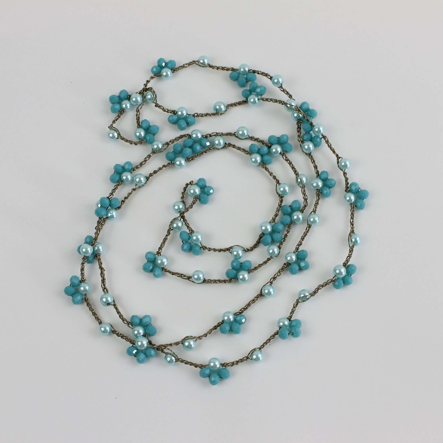 Senti la magia del mare: collana in tonalità azzurre con filato gioiello e perline per un’eleganza naturale.